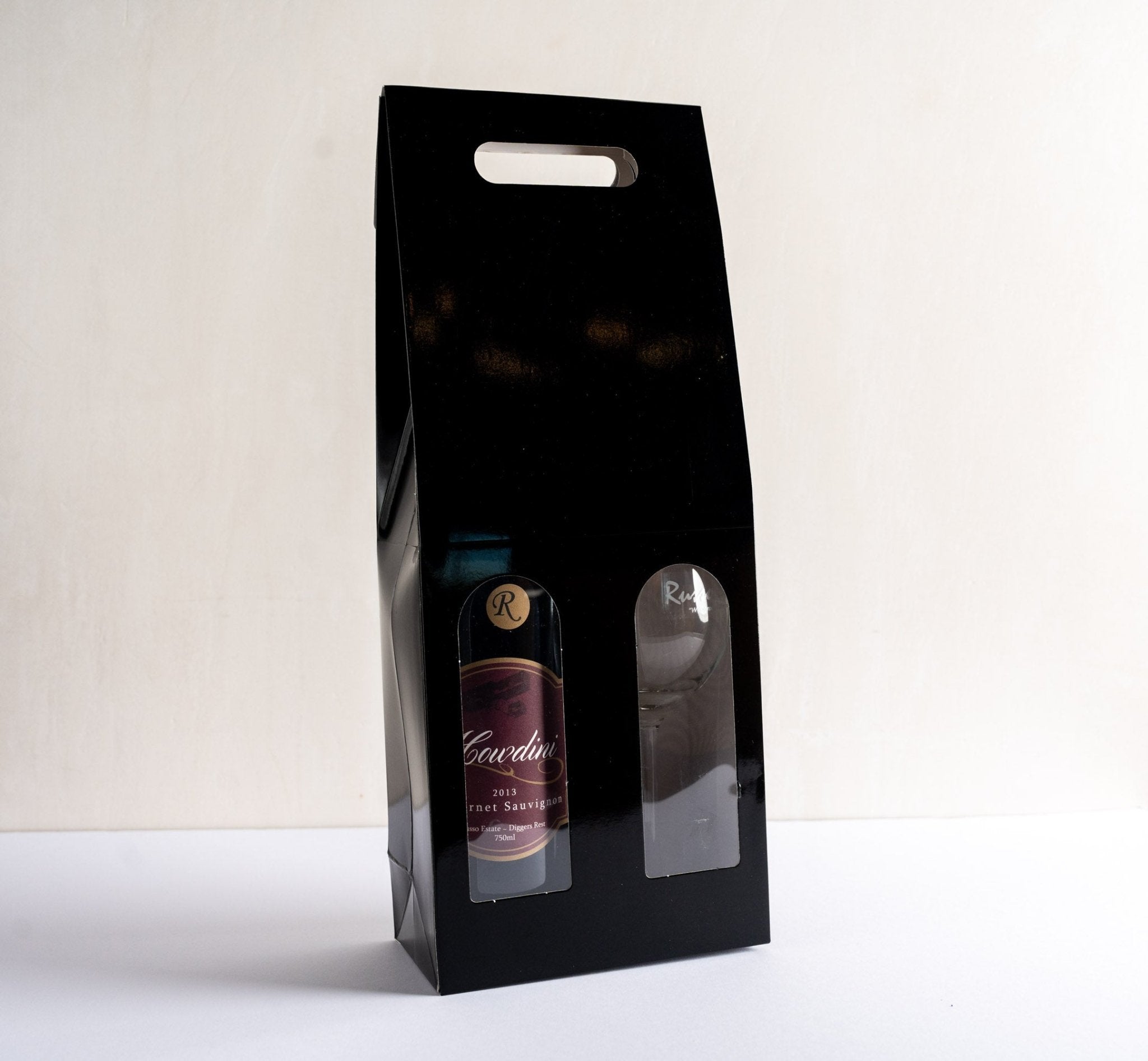 a gift box with a bottle of red wine and a wine glass, front facing